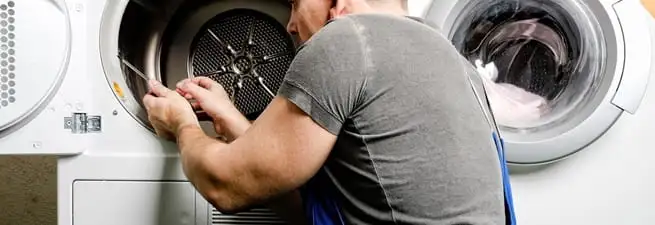 Dryer repair technician fixing a clothes dryer drum in Stamford, CT