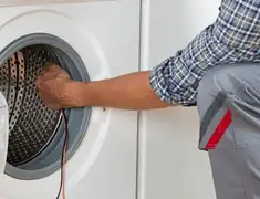 Dryer repair technician diagnosing and servicing a clothes dryer in Stamford, CT
