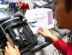 Vacuum repair technician servicing internal components on a workbench in Stamford, CT
