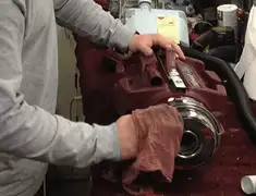 Vacuum repair technician cleaning and servicing a vacuum motor in Stamford, CT