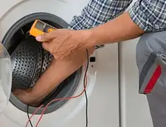 Washing machine repair technician testing a front-load washer with diagnostic tools in Stamford, CT