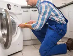 Washing machine repair technician servicing a front-load washer in Stamford, CT